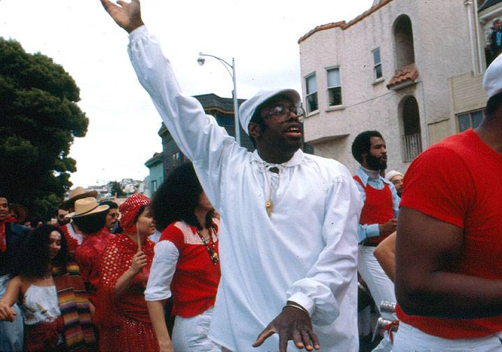 Black-guy-in-white-w-arm-extended.jpg